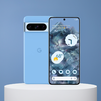 A light blue smartphone with a triple-lens camera on the back stands upright next to a similarly colored phone lying face up, showing a map and weather widget on the AMOLED display. Both are Google Pixel 8 Pro smartphones with KosherOS 14.